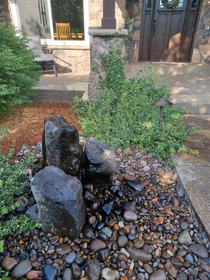 From the front porch, listen to the fountain and greet neighbors as they pass by