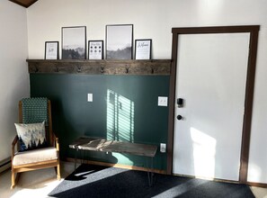 Front entryway w/ large coat rack and bench which make putting shoes on a breeze