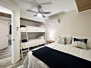 2nd bedroom with queen bed and bunk beds. Also has AC/heater and ceiling fan.