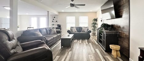 Living Room with love seat, couch and recliner to sit and relax on.