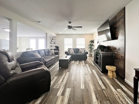Living Room with love seat, couch and recliner to sit and relax on.