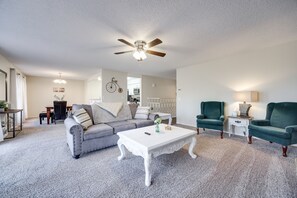 Open and bright common area with living room, dining room, and kitchen. 