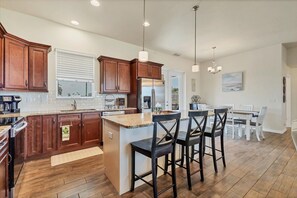 Fully-equipped kitchen overlooking the living & dining areas. Kitchen island seats 3