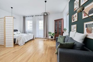 Another angle of the same living room showcasing the seating area and wooden floors.
