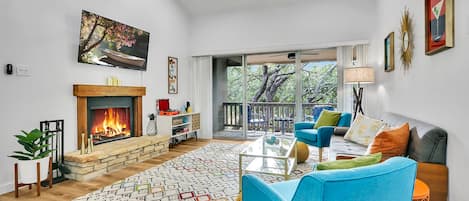 Living room with fire place and flat screen television.