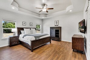 Master bedroom with a California king size bed