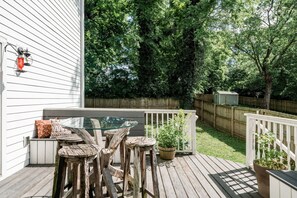 Large fenced in backyard with plenty of seating.