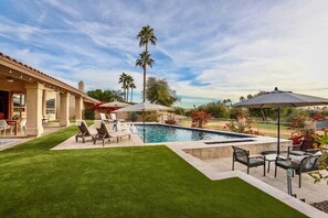 Luxury living with heated pool multiple lounge areas, yard games and pool toys. 