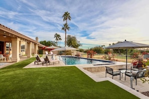 Luxury living with heated pool multiple lounge areas, yard games and pool toys. 