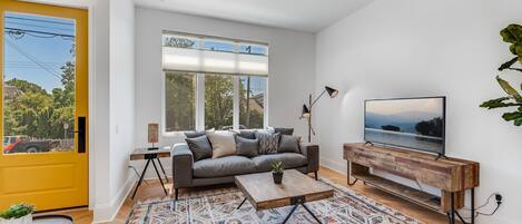 Living Room with gorgeous, natural light. Remote controlled blinds for privacy.