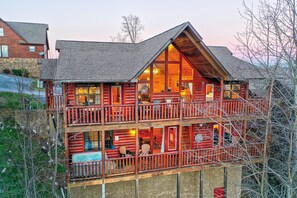 True log cabin with expansive decks on both levels for relaxing and hot tubbing.