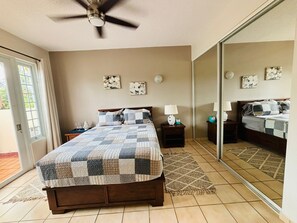 Cozy bedroom with a large comfortable bed, TV and access to the terrace