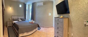 Second bedroom with 55 inch smart TV, mini fridge, microwave, and coffee pot