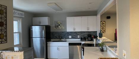 Kitchen looks into living and dining areas