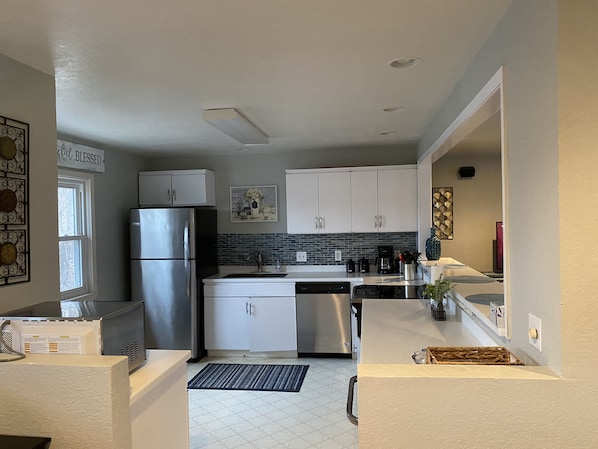 Kitchen looks into living and dining areas