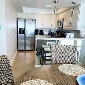 Full kitchen with a bar and bar stools