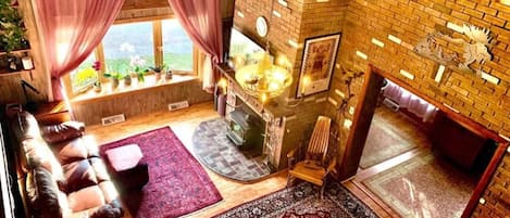 Spacious living room with cathedral ceilings and a wood-burning fireplace insert