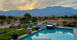 Enjoy the sun setting behind the mountains from the backyard