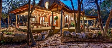 The cabin/house restled in the woods