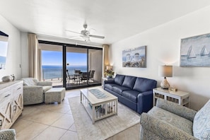 Living room w/ access to the large patio and views of the ocean.