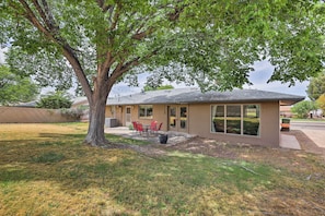 Fenced, private backyard with large shade tree