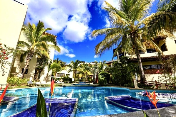 Main pool steps away from the villa .