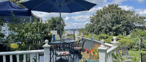 Lovely view of the ocean harbor from back deck. Chairs and wicker slider.