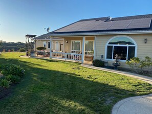 View of our backyard with solar, patio, and two outdoor living spaces.