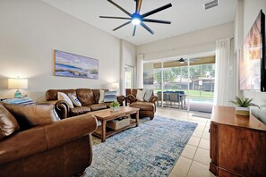 Living Room with view to the pool and backyard.