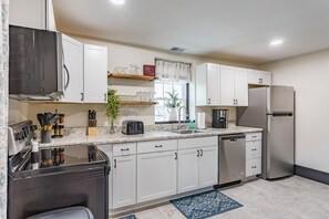 Full size kitchen with refrigerator, electric range, microwave, and dishwasher. 