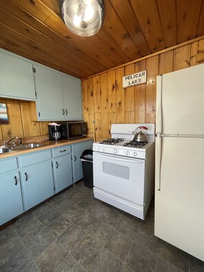 Kitchen with refrigerator, stove/oven, and microwave