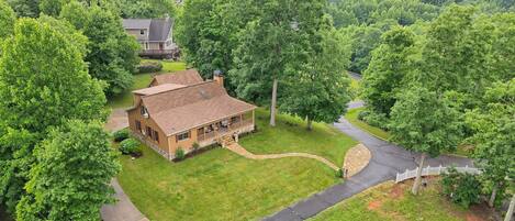 Aerial view of the property and surrounding large yard for family fun!