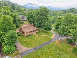 Aerial view of the property and surrounding large yard for family fun!