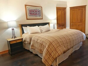 King size bed and dresser. Extra pillows, fans, and air mattress in closet. 