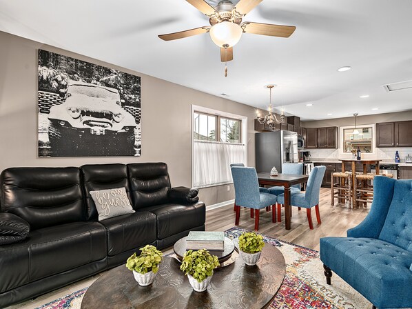 Upstairs living area with reclining sofa.
