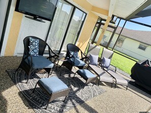 Comfortable seating in lanai.  Perfect for morning coffee and watching kids swim