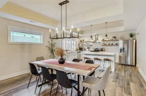 Dining area seats eight at table and three at kitchen island