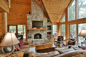 Two story vaulted greatroom with wood burning stone fireplace.