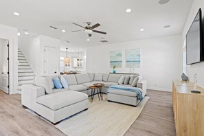 Spacious, updated coastal design with 13ft tall ceilings throughout