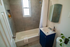 Bathroom 1 of 2 (1st floor): nestled between one bedroom and the living area.