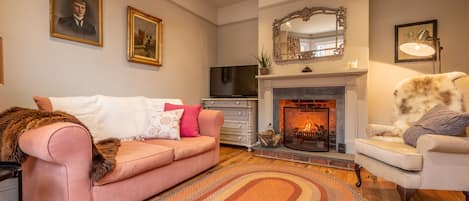 Norfolk House: A warm and inviting sitting room with open fire