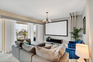 Stylish living area of the condo in Kissimmee Florida - Unwind in the living area with movie projector - Stylish furniture arrangement providing comfort and a cohesive look - Cozy seating for relaxation