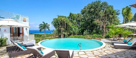 Swimming pool with sun loungers