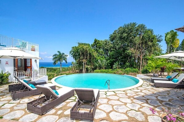 Swimming pool with sun loungers