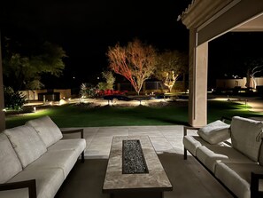 Beautiful sitting area and fire table to gather with friends at night
