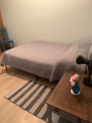 Double bed in small cozy bedroom on the main floor . No windows in this room. 