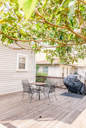 The back porch has a grill and a table for 4