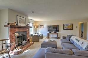 Living room with wood burning fireplace and comfortable seating