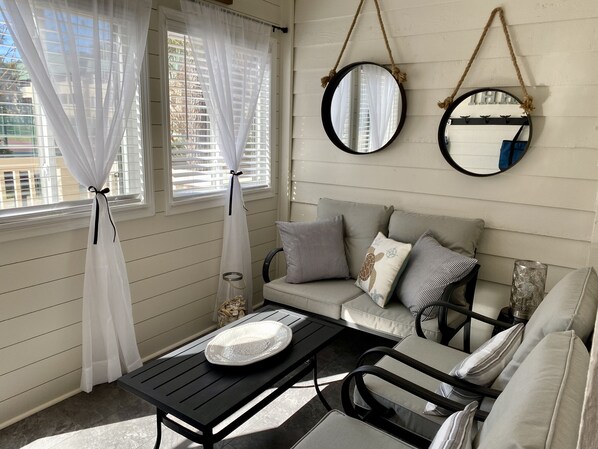 Enclosed sun porch overlooking the tennis courts - perfect for morning coffee!