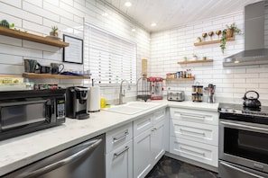 Full kitchen with stainless steel appliances, popcorn machine & pancake maker.